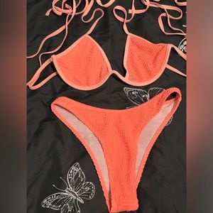 It’s like a bunt/ neon orange color, size- L, the bottoms are kinda high waisted